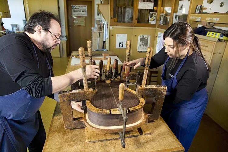 Hermann Hauser III and Kathrin Hauser working on a guitar in their shop