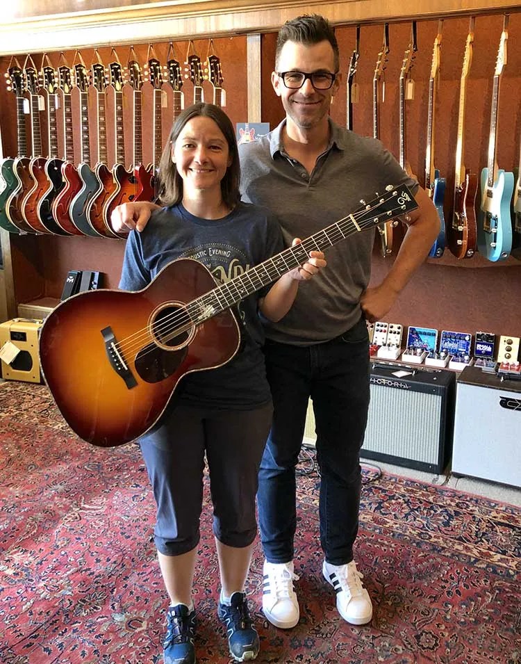 The Music Emporium’s Andy Cambria with the proud owner of a new custom Santa Cruz guitar.