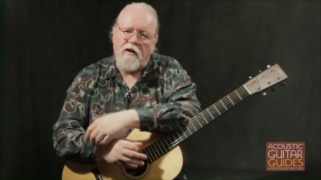 Orville Johnson posing with his guitar