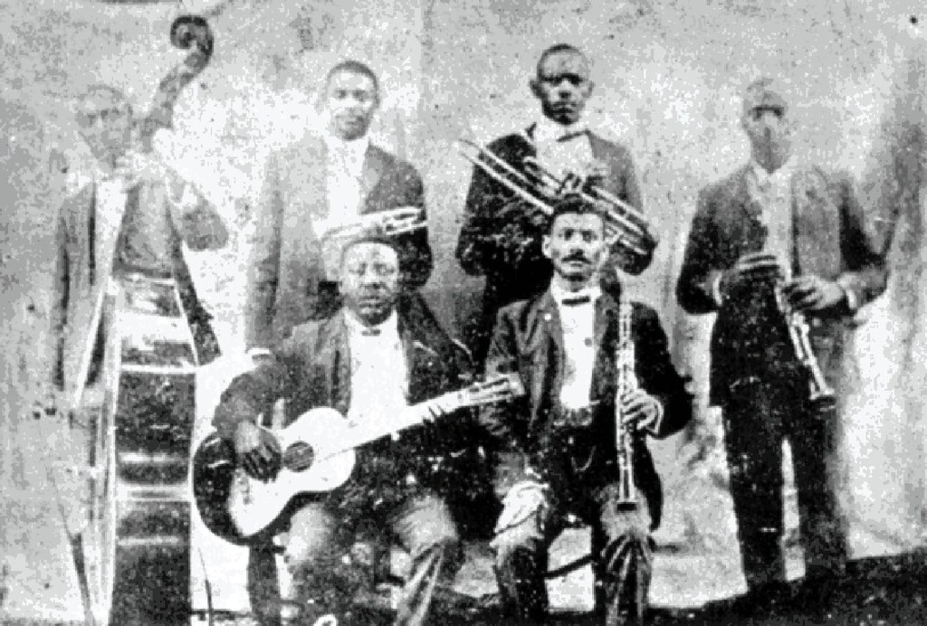 A musical group pictured in black and white.