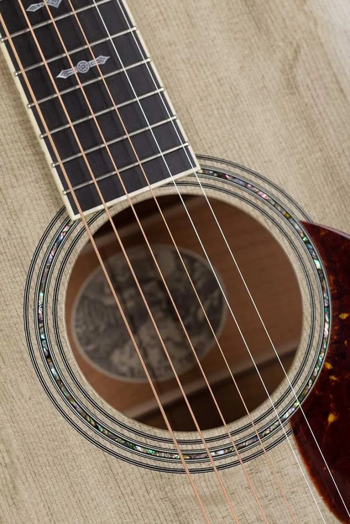 Closeup of a Collings OM3 custom acoustic guitar soundhole