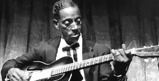 Fred McDowell with his guitar