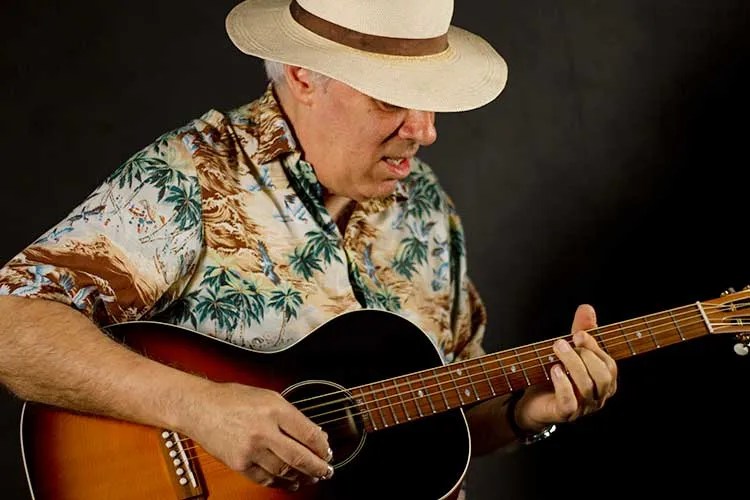 Fred Sokolow playing a blues riff on an acoustic guitar
