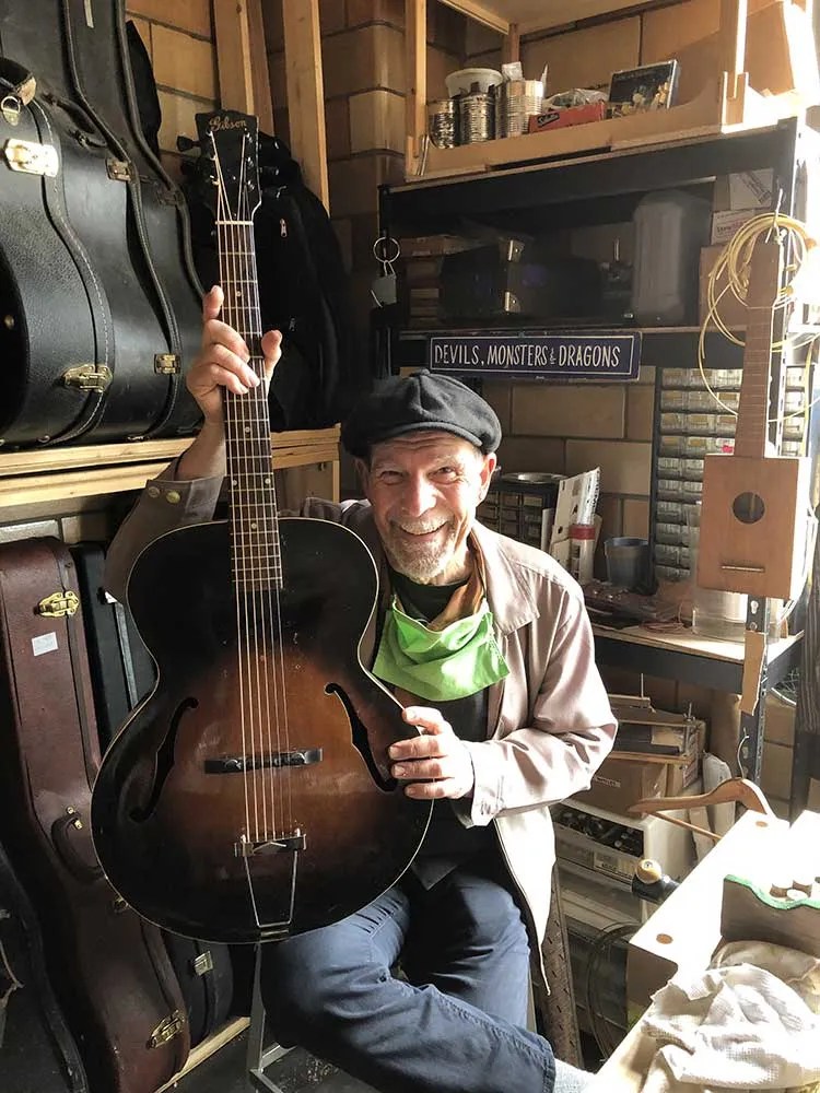 Steve James with an old Gibson archtop in his Seattle workshop