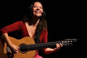 Cecilia Zabala playing acoustic guitar